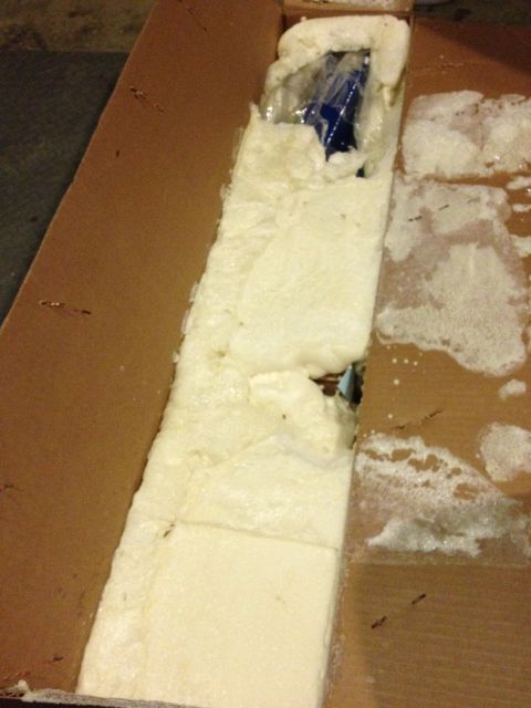 1995 Ford Bronco - A blue object is partially visible within a cardboard box, secured by foam padding.