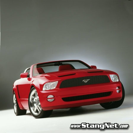 1990 Ford Bronco - A red convertible sports car is shown from a three-quarter front view against a neutral background.