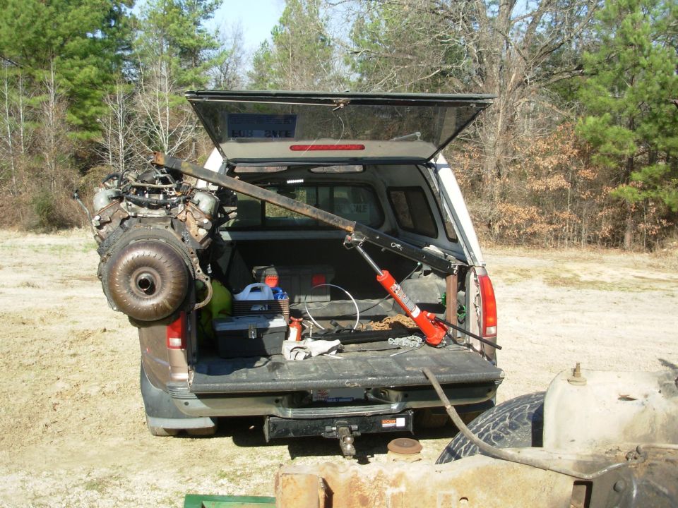 This was with the long boom swung straight to the side, which puts the most load on the bedwall & brace.  There was some creaking from the camper sliding on the Rhino, and the truck is leaning hard (note the distance from the mud flaps to the ground), but even with this long arm & heavy lift, the bedwall didn't bend, and the t/g still closes & opens.