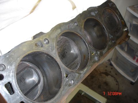 1995 Ford Bronco - Close-up view of a used engine cylinder block, showing the internal cylinders and pistons.