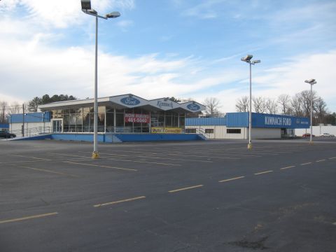 1968 Shelby GT500 - Exterior view of Kimnach Ford dealership on a cloudy day, an empty parking lot and a prominent "Now Hiring" sign.