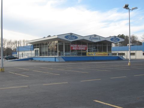 1968 Shelby GT500 - The Kimnach Ford dealership features a modern facade with large windows and prominent signage.