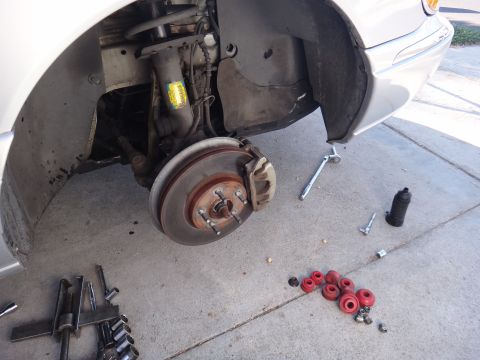 2000 Lincoln Continental - Front suspension components and tools are visible, suggesting maintenance or repair work on a vehicle.