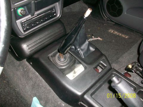 2000 Isuzu Vehicross - Center console and manual shifter in a vehicle interior. The floor mat has 'ISUZU' branding.