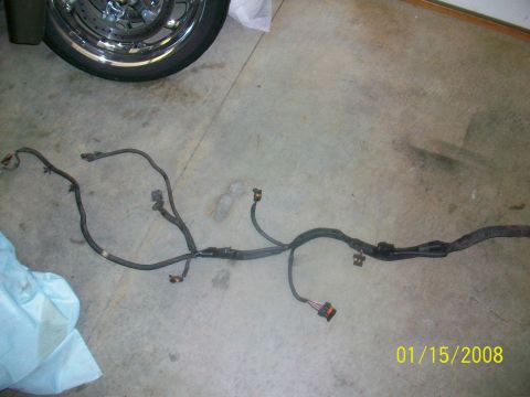 2000 Isuzu Vehicross - A vehicle wiring harness is shown on a concrete floor, with a motorcycle wheel visible in the upper left corner.
