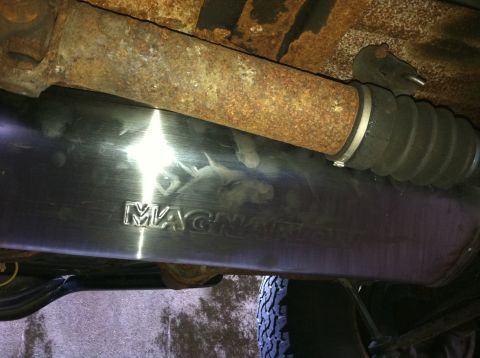 1996 Ford Bronco - Close-up view of a vehicle's undercarriage, focusing on an exhaust component.