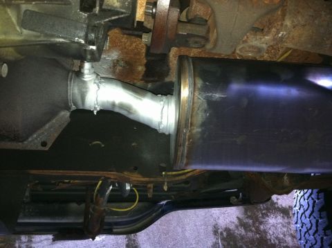 1996 Ford Bronco - Custom exhaust pipe and muffler installation visible from underneath a vehicle.