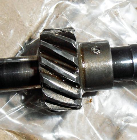 1990 Ford Bronco - A close-up view of a damaged automotive gear, showing significant wear and chipped teeth.