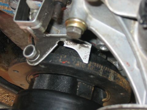 1992 Ford Bronco - Close-up view of a timing pointer and crankshaft pulley, showing degree markings for engine timing adjustments.