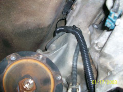 2000 Isuzu Vehicross - Close-up view of vehicle drivetrain components, including wiring and a bolted flange.
