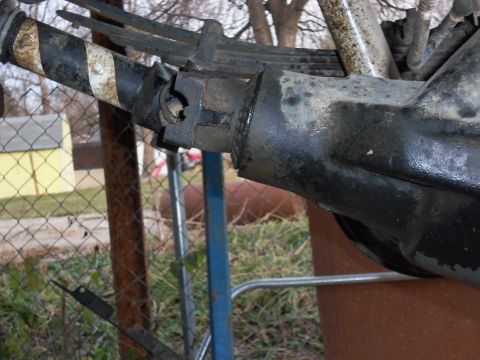 1989 Ford Bronco - The rear axle assembly shows signs of wear and tear, with visible leaf springs and a connection point for the driveshaft.