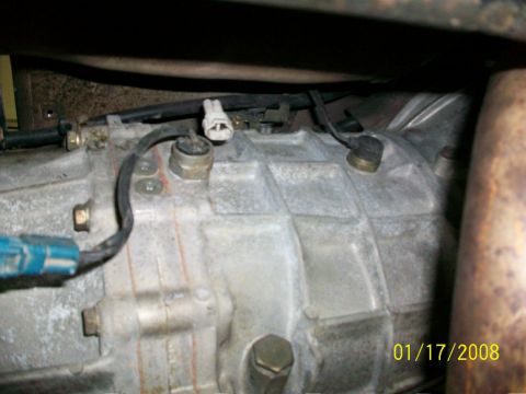 2000 Isuzu Vehicross - Close-up of a vehicle's transmission casing, sensors and electrical connectors, with a visible date stamp.