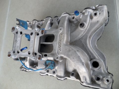 1973 Ford Ranchero - Edelbrock Performer 400 intake manifold shown with blue vacuum fittings and a blue wire attached.