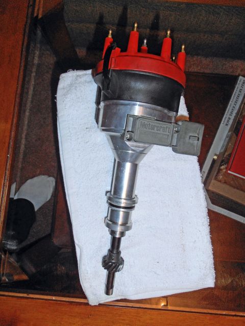 1990 Ford Bronco - Motorcraft ignition distributor with red cap and gear-driven shaft laid on a folded white towel.