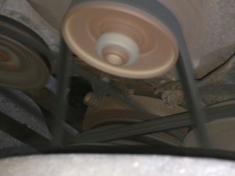 1979 Ford Bronco - Close-up of engine belts and pulleys, some blurred from motion. Supermotors.net logo visible.