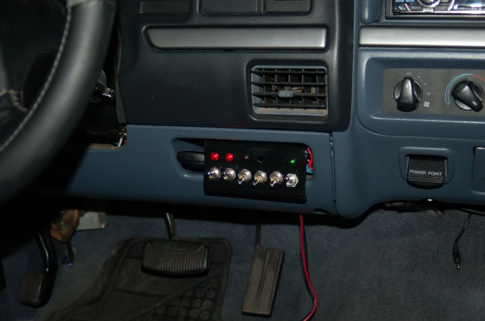 1992 Ford F-150 interior with aftermarket switch panel, red and green indicator lights, and a power point