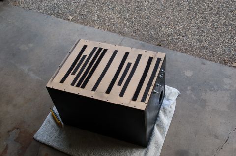 1992 Ford F-150 - A custom subwoofer box sits on a towel on a concrete surface, a wood top with black accent stripes.