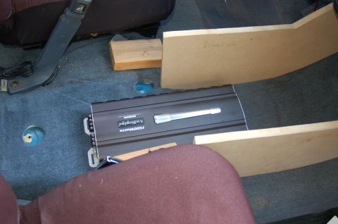 1992 Ford F-150 - Custom audio amplifier installation in a vehicle's interior, with unfinished wood panels.