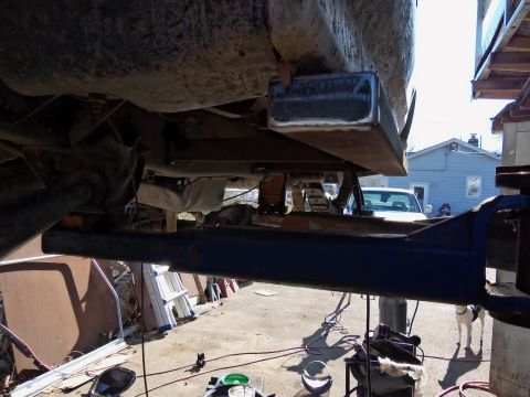 1989 Ford Bronco - The underside of a vehicle is shown with newly welded metal components attached to the frame.