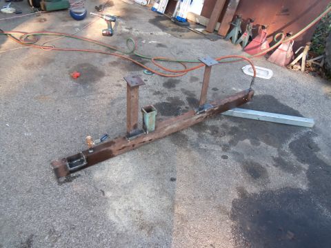 1989 Ford Bronco - Custom metal fabrication project, possibly for a vehicle, is shown on the ground with tools nearby.