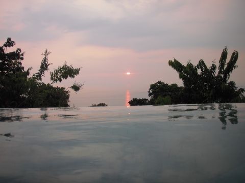 1993 Ford Bronco - Infinity pool scene at sunset, with a watermark for SUPERMOTORS.net visible.