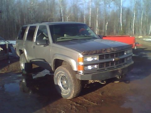 2000 Chevrolet Tahoe - This silver SUV's grille design suggests a mid-1990s model year, not a 2000 Chevrolet Tahoe.