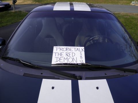 1997 Ford Probe - Dark blue car with white racing stripes and a sign on the windshield.