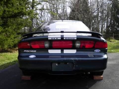 1997 Ford Probe - Rear view of a dark green 1997 Ford Probe, racing stripes and a spoiler.