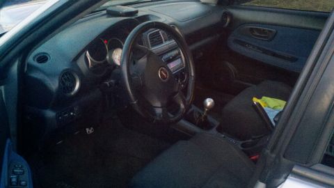 1999 Mercury Grand Marquis - Interior view of a car's dashboard, steering wheel, and gear shifter.