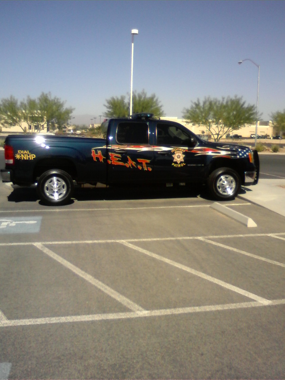 Dark blue Nevada Highway Patrol pickup truck with H.E.A.T. graphics parked in a lot