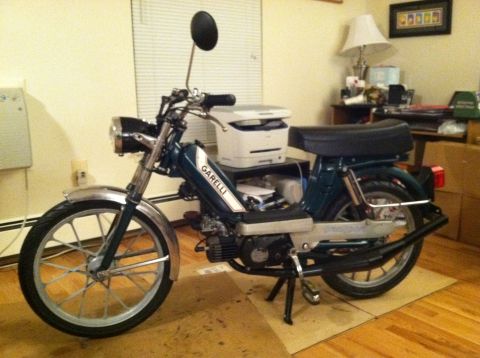 1981 Garelli Rally Sport - A dark green Garelli moped is parked indoors on a piece of cardboard, with a printer visible behind it.