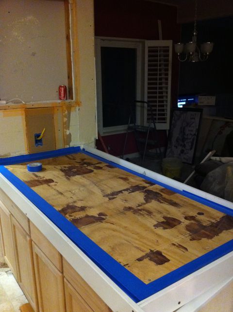 1989 Yugo Cabrio - A countertop is being prepared for finishing, with blue painter's tape outlining the plywood surface.