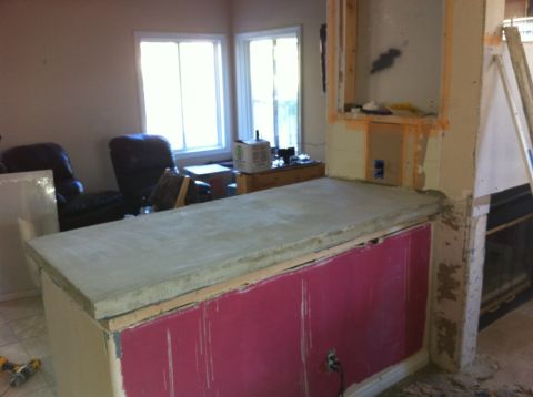 1989 Yugo Cabrio - The image shows a kitchen counter in the process of renovation, with unfinished concrete and exposed framing.