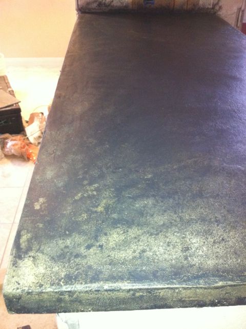 1989 Yugo Cabrio - A close-up view of a dark, textured surface with gold flecks, possibly a countertop or table.
