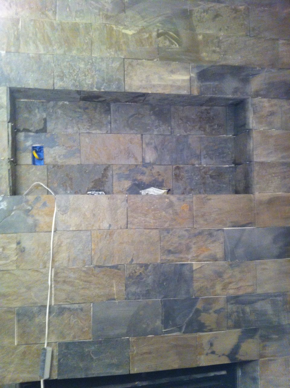 Stone wall with recessed shelf and electrical outlet