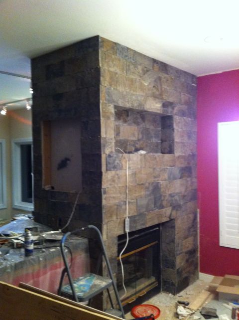 1989 Yugo Cabrio - Stone fireplace installation in progress, showing the facade and surrounding area with construction supplies.