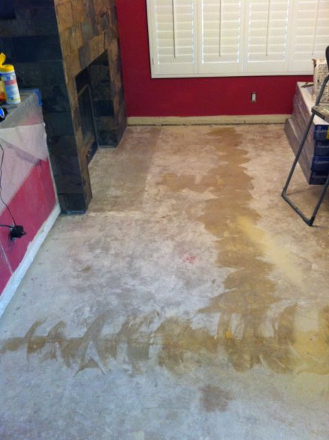 1989 Yugo Cabrio - The concrete floor shows significant staining and appears to be undergoing some form of renovation or repair.