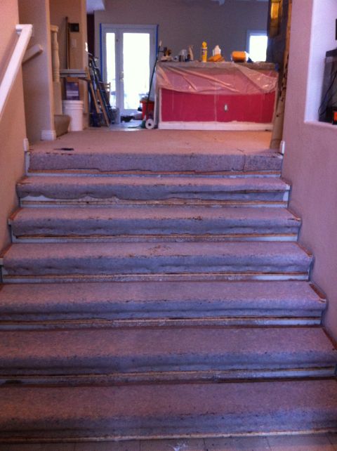 1989 Yugo Cabrio - Interior stairs show signs of wear, with a room undergoing renovation in the background.