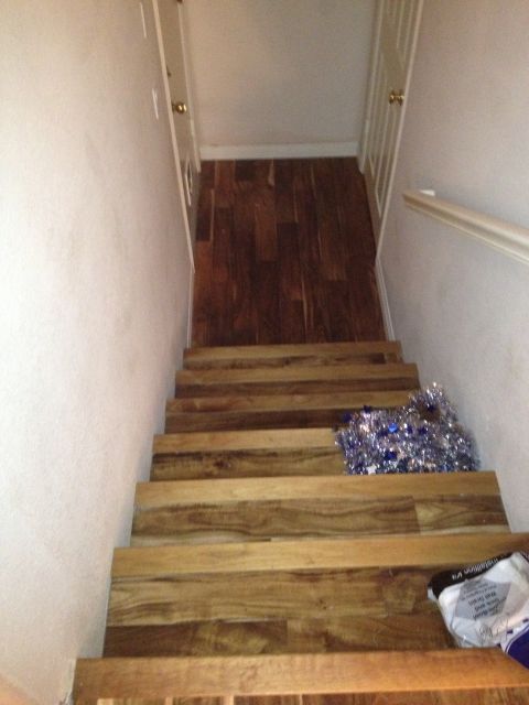 1989 Yugo Cabrio - A staircase with wooden steps and a pile of blue tinsel on the right side.
