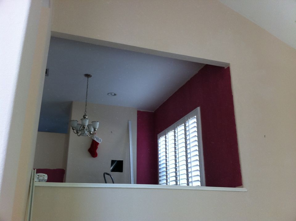 Interior view of a room with a chandelier, Christmas stocking, and window blinds