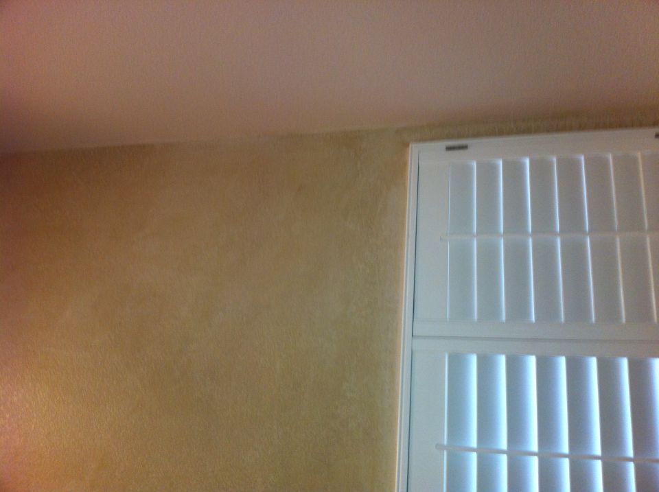 Interior wall with textured finish next to white louvered shutters. "SUPER MOTORS" logo visible