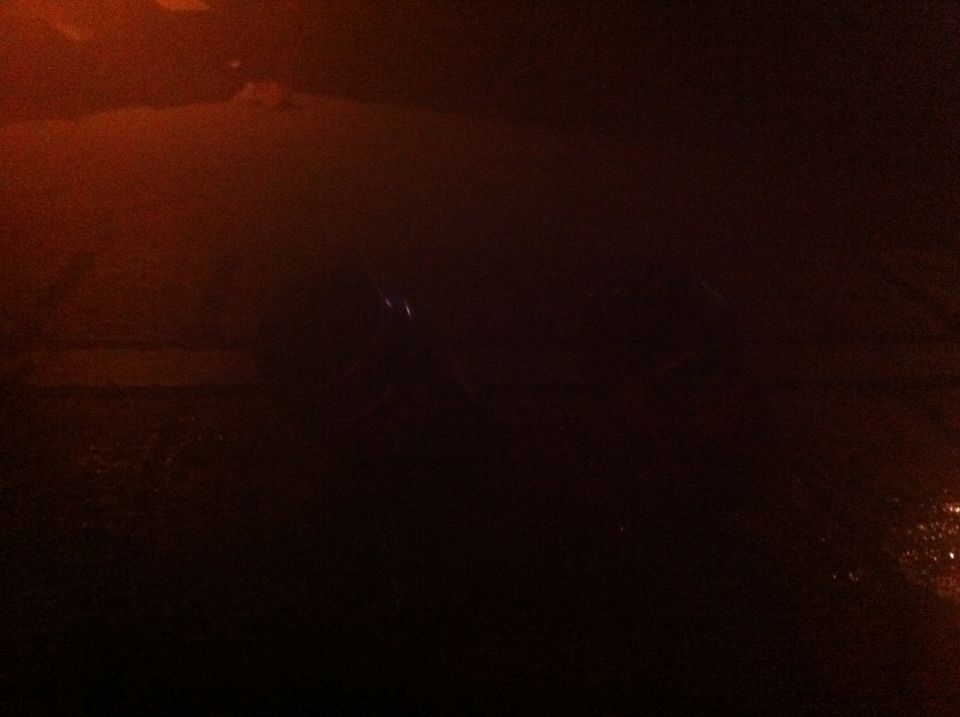 dark car interior, dashboard visible, some lights reflecting