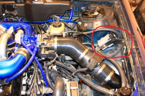 1993 Ford Taurus - Close-up of an engine bay, highlighting custom blue piping and a circled electrical connector.