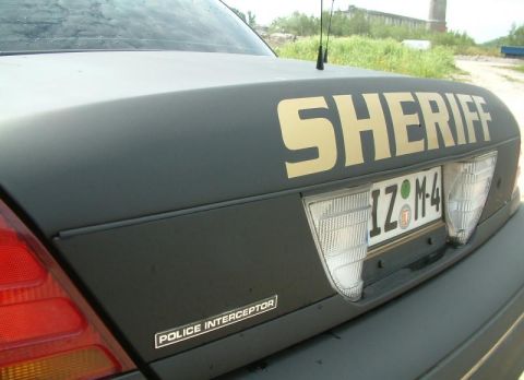 2003 Ford Crown Victoria - Rear view of a dark Sheriff's vehicle, identified as a 2003 Ford Crown Victoria Police Interceptor.