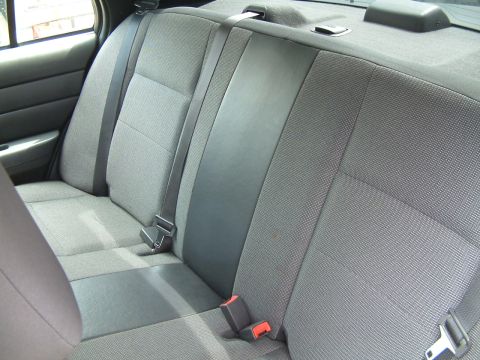 2003 Ford Crown Victoria - Interior view of a vehicle's rear seat, showing fabric upholstery and seat belts.