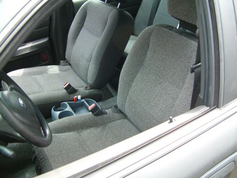 2003 Ford Crown Victoria - Interior view of a 2003 Ford Crown Victoria, highlighting the front seating area and console.