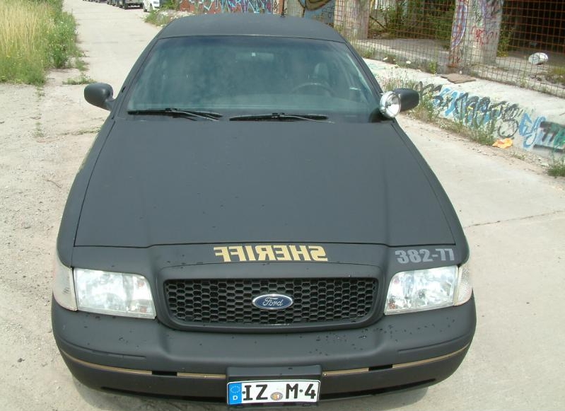 Front view of a black 2003 Ford Crown Victoria police car with "SHERIFF" text