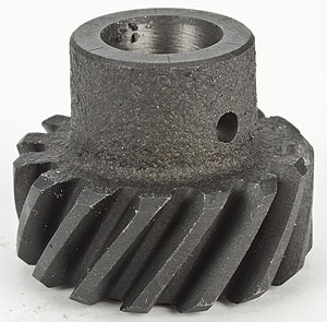 1990 Ford Bronco - Close-up of a metal gear with helical teeth, likely an automotive part.