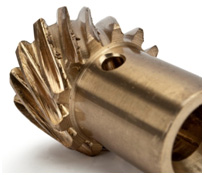 1990 Ford Bronco - Close-up view of a bronze gear, likely a component from machinery.