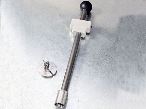 1990 Ford Bronco - A close-up view of a distributor shaft assembly and a separate metal component.